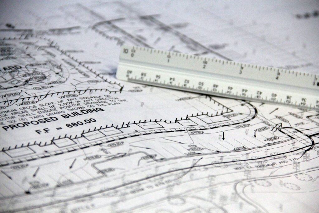 Escalímetro sobre planos de obra para medir el croquis de un número generador